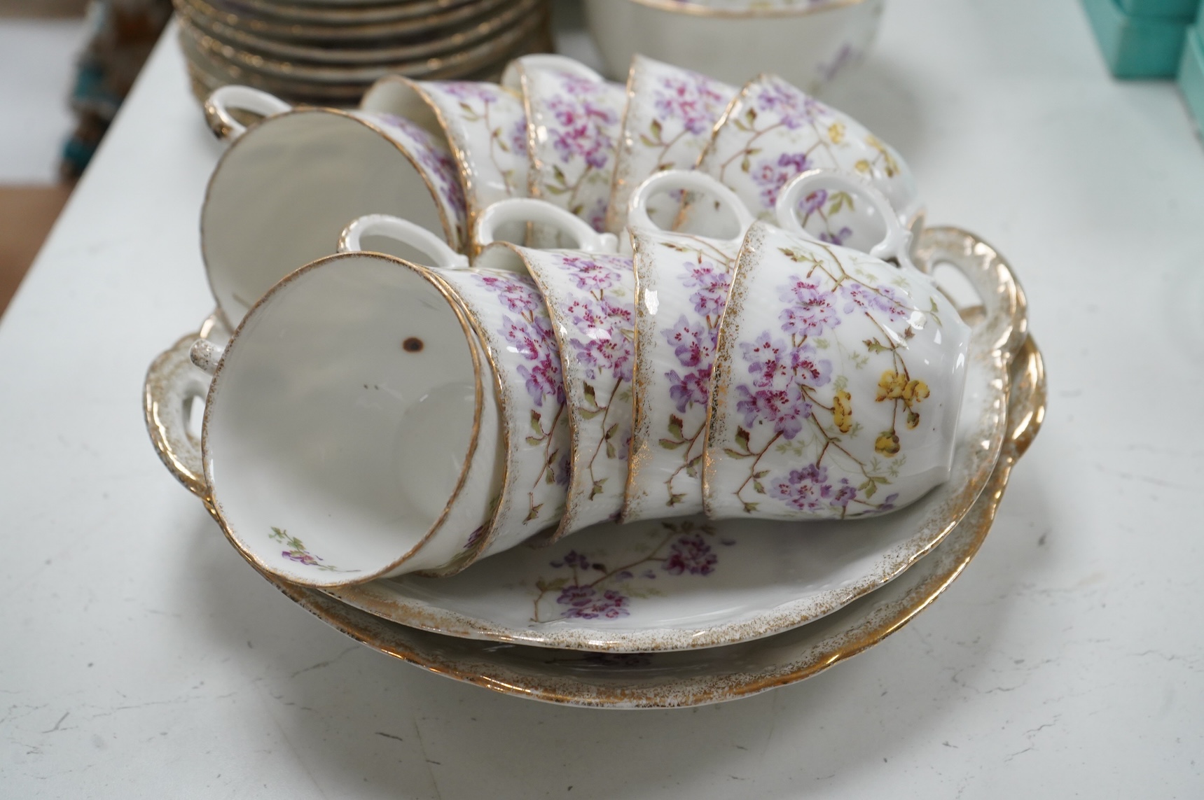 A KPM style floral porcelain part tea service, largest 27cm in diameter